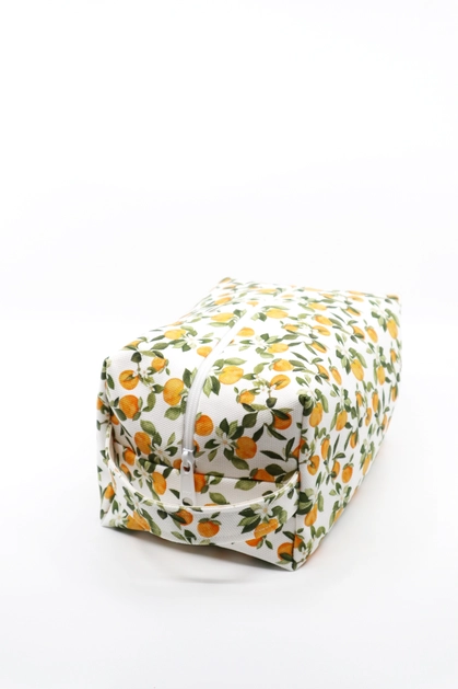 Makeup bag in Clementine print, with various small clementine fruits, white flowers and green leaves