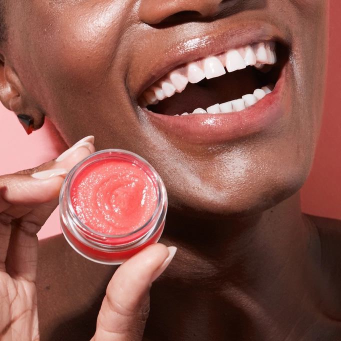 Woman smiling and hold watermelon lip balm